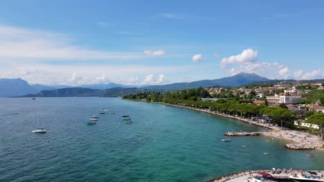 Flying-a-drone-over-a-port-on-the-coast-of-Lake-Garda,-Italy