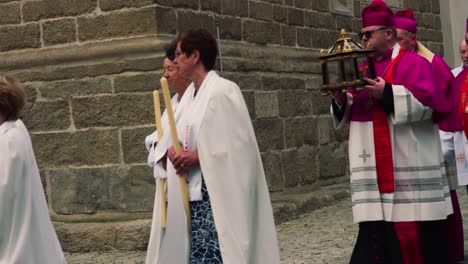 Procession-of-believers-and-church-dignitaries-dressed-in-white-robes