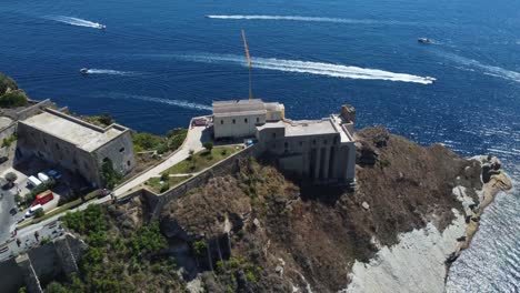 Santa-Margherita-Monastery-in-the-Gulf-of-Naples-at-Procida-Island,-Italy,-Drone-shot