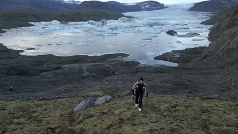 Young-Man-Walks-Around-Svinafellsjokull-Glaciers-Landscape-Iceland-Aerial-Drone-View