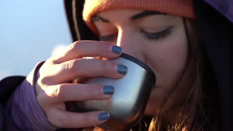 Portrait,-Young-Woman-Drinks-Water-from-Metal-Glass-at-Cold-Winter-of-Iceland-Jökulsárlón-Landscape-National-Park-Vatnajökull