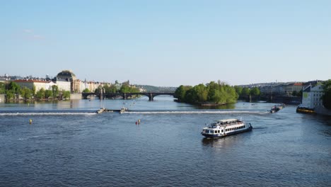 Panoramic-view-of-a-cruise-on-the-Vltava-River-with-the-view-of-Charles-Bridge-in-the-background,-Prague,-Czech-Republic
