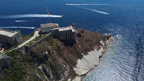Santa-Margherita-Monastery-in-the-Gulf-of-Naples-at-Procida-Island,-Italy,-Aerial-pullback-shot
