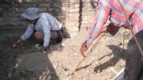 A-woman-who-is-an-NGO-worker-is-removing-plastic-and-garbage-with-her-hands-without-any-fear