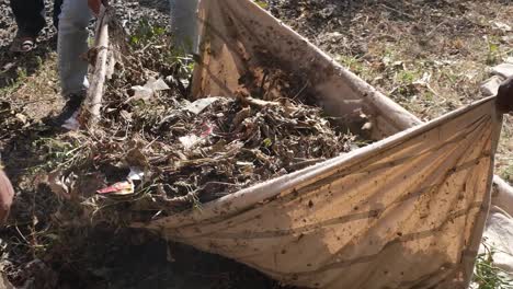 close-up-scene-of-cleaning-by-NGO-workers-removing-and-filling-garbage-and-plastic-waste