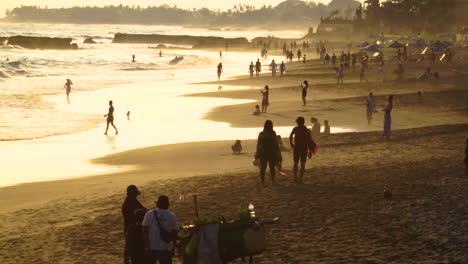 People-on-vacation-in-Bali,-Batu-bolong-beach-in-Canggu-on-sunset