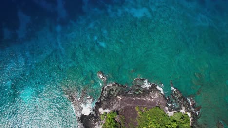 Flying-over-Manini-Beach-in-Big-Island-of-Hawaii---turquoise-water-with-coral-reef-on-sunny-day