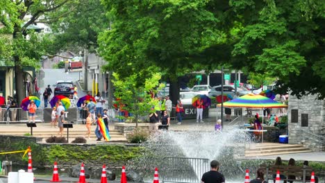 Aerial-wide-shot-of-fountain-in-park-during-LGBTQ-Pride-Festival-in-american-town-during-summer