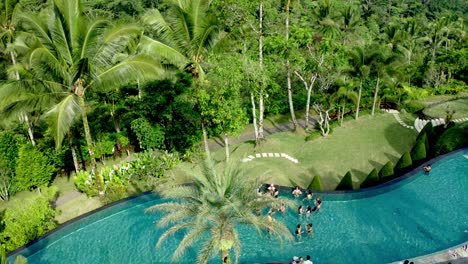 Aerial-view-of-people-swimming-in-pool-while-on-holiday