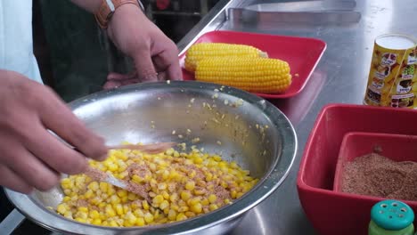 Close-up-scene-of-removing-kernels-from-corn-and-adding-pepper-and-lemon-to-it-which-is-very-yummy-and-tasty-to-eat
