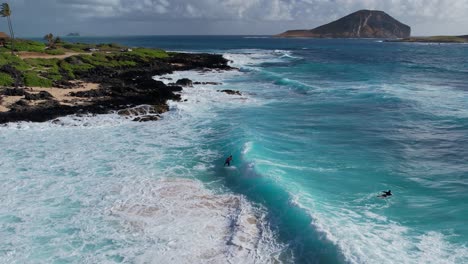 Surfer-catching-turquoise-wave-in-slow-motion-on-a-clear-morning-in-Oahu-Hawaii