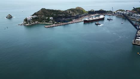 Aerial-of-Santa-Marta-city-on-the-Caribbean-Sea-in-the-northern-Colombian-department-of-Magdalena-drone-fly-above-commercial-port-with-container-and-cargo-boat
