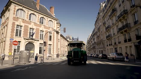 Chatelet-96-vintage-route-bus-on-the-streets-seen-approaching-with-rental-bicycles-left,-Looking-back-shot