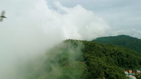 4K-Cinematic-nature-aerial-footage-of-a-drone-flying-over-the-beautiful-mountains-of-Mon-Jam-next-to-Chiang-Mai,-Thailand-on-a-sunny-day