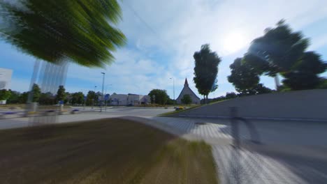 Hyperlapse-Shot-of-Movement-over-City-Fountain-Towards-Modern-Church