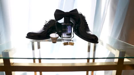 Groom's-Accessories-with-the-bow-tie-on-the-table-for-the-Wedding-Day