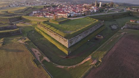 Reveal-shot-of-Fortress-village-Almeida-Portugal-with-sunrise,-aerial