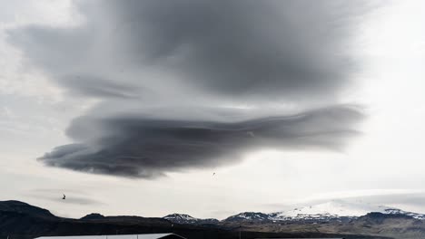 Heavy-mysterious-dark-clouds-time-lapse-on-white-sky-above-glacier
