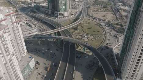 aerial-drone-footage-of-complex-highway-system-and-large-buildings-in-Karachi,-Pakistan