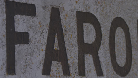 Farol-sign-closeup-pointing-to-famous-Nazare,-Portugal-surf-beach-break