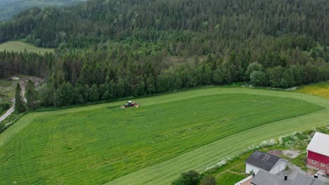 Tractor-Working-In-Green-Field-In-The-Countryside---aerial-drone-shot