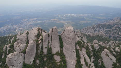 Montserrat-Nature-Park-mountain-top-with-the-view-of-Barcelona-city-under-grey-polluted-sky-due-to-climate-change,-Spain