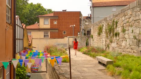 Rückseite-Einer-Frau,-Die-Durch-Das-Malerische-Dorf-Mit-Farbenfroher-Straße-In-Porto,-Portugal,-Spaziert