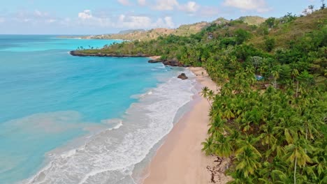 Playa-Colorada-beach-between-turquoise-waters-and-palm-forest,-Las-Galeras,-Samana-in-Dominican-Republic