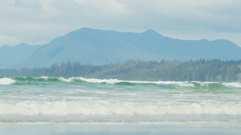 Vancouver-Island-Coast-with-Waves-and-Mountainous-Forest-Background