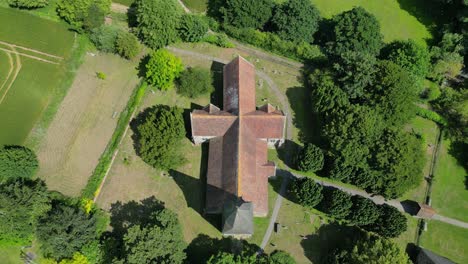 A-top-down-pull-out-shot-of-St-John-the-Evangelist-church-in-Ickham-village,-Kent