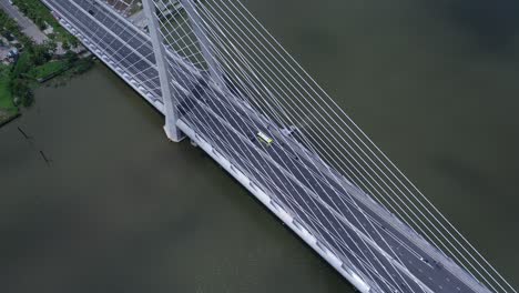Aerial-orbit-view-of-suspension-bridge-over-river-with-road-traffic