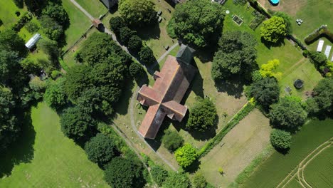 A-top-down-roll-shot-of-the-St-John-the-Evangelist-church-in-Ickham,-Kent