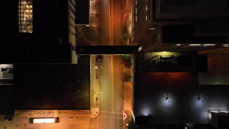 Intersection-in-Davenport,-Iowa-at-night-with-drone-video-overhead-looking-down-and-moving-forward