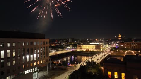 Des-Moines,-Iowa-fireworks-over-city-and-state-capitol-building-on-Independence-Day-with-drone-video-moving-up