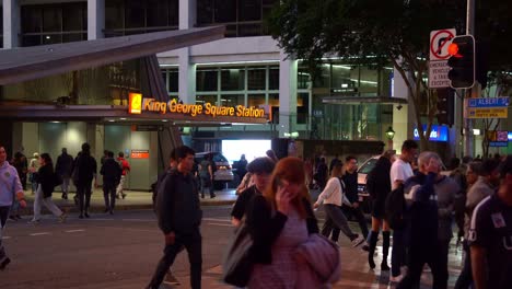 Grandes-Enjambres-De-Personas-Cruzando-La-Calle-En-Albert-Y-Adelaide-Street-En-La-Ciudad-De-Brisbane-Entre-La-Estación-De-Autobuses-King-George-Square-Y-El-Centro-Comercial-Queen-Street-En-La-Noche,-Tiro-Estático
