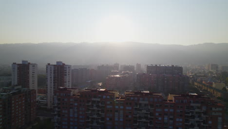 Morning-Sunrise-Over-Urban-City-Area-With-Tall-Residential-Buildings-And-Green-Trees