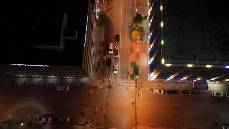 Davenport,-Iowa-intersection-at-night-with-drone-video-tilting-up-to-skyline