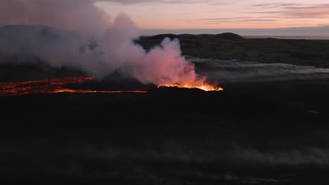 Iceland-volcano-eruption-in-black-basalt-environment,-aerial-footage