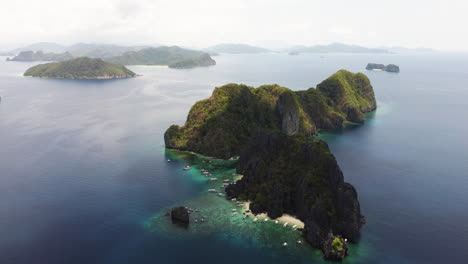 Magnificent-rugged-Philippine-island-with-lots-of-Banka-boats