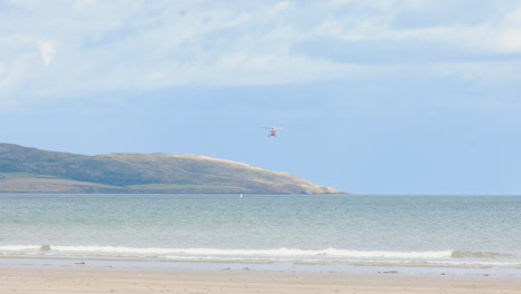 Irish-Rescue-helicopter-hoovers-over-the-ocean-practicing-manoeuvers-and-rescue-drill