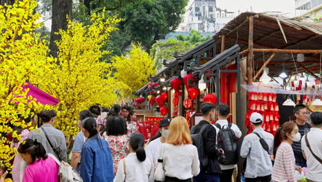 The-vibrant-culture-of-Vietnam-during-Lunar-New-Year-as-locals-decorate-the-streets-with-traditional-household-items,-red-lanterns,-and-yellow-apricot-flowers