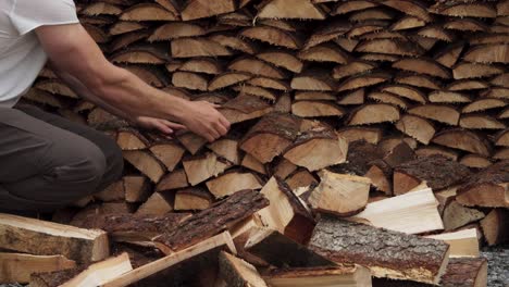 Man-Is-Arranging-Cut-Lumber-Into-Stacked
