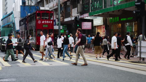 Double-decker-bus-waiting-for-people-to-finish-crossing-the-road-in-Hong-Kong