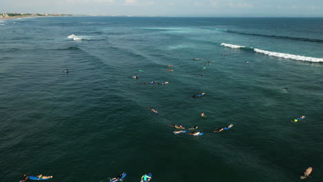 Batu-Bolong-Beach-scene,-surfers-enjoying-sunny-day-to-catch-wave