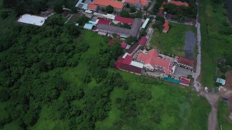 Thủ-Thiêm-Parish-Church-and-the-Lovers-of-the-Holy-Cross-Convent-are-the-oldest-French-Colonial-buildings-in-Ho-Chi-Minh-City,-Vietnam-Aerial-view-flying-over-church,-convent-and-other-buildings