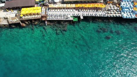 Top-down-Drone-shot-of-Kaş-beach-clubs-in-Antalya-region-of-Türkiye