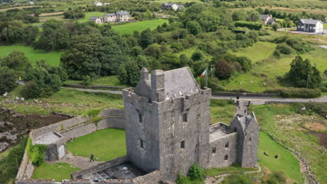 Aerial-Shot-Orbiting-Historic-Dunguaire-Castle-in-County-Galway,-Ireland