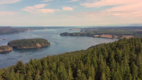 Aerial-View-of-Treetops,-Ocean-Islands-and-Distant-Campbell-River