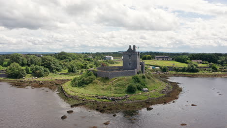 Aerial-Shot-Rotating-Around-Dunguaire-Castle-in-County-Galway,-Ireland