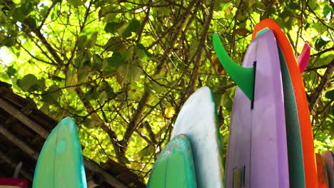 Colourful-surfing-boards-at-rental-place-on-Tanjung-Aan-beach,-Lombok-Indonesia